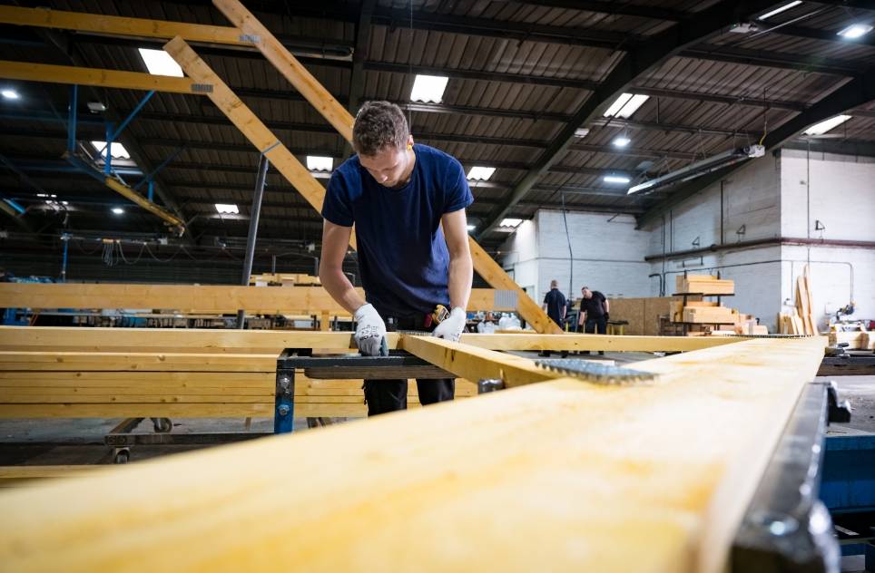 A Donaldson Direct staff member checking a roof truss meets stringent requirements